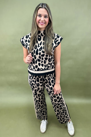 Woman wearing a leopard print outfit on a green background