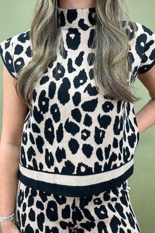 Person wearing a leopard print outfit with a green background