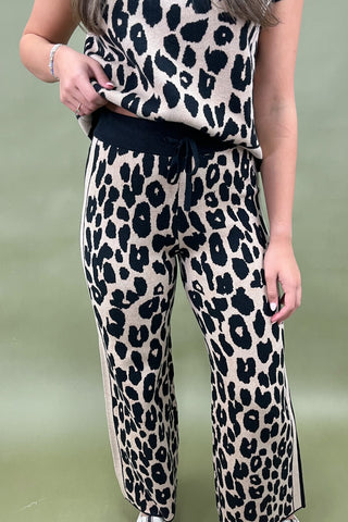 Person wearing a leopard print outfit on a green background