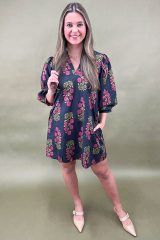 Woman wearing a floral dress on a plain background