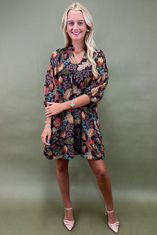 Woman wearing a floral dress against a green background