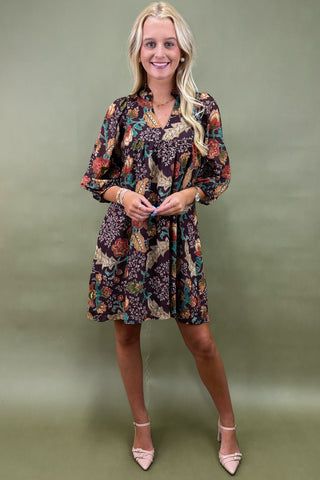 Woman wearing a floral dress against a green background