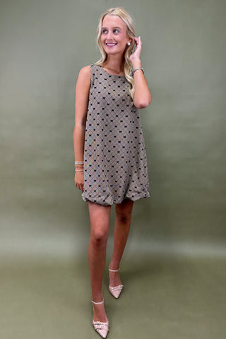 Woman wearing a burgundy dress against a plain background