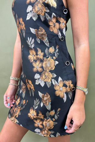 Navy floral dress with brown and white flowers on a plain background