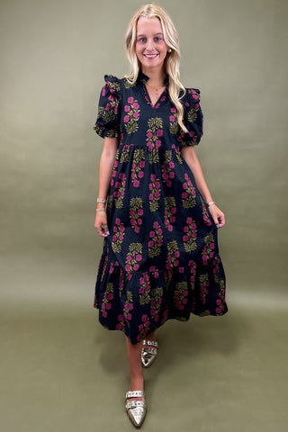 Woman wearing a floral dress against a green background