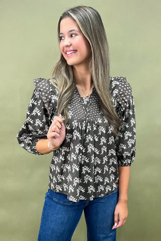 Brown floral smocked blouse with ruffle shoulders and balloon sleeves paired with wide-leg denim jeans for a chic fall outfit