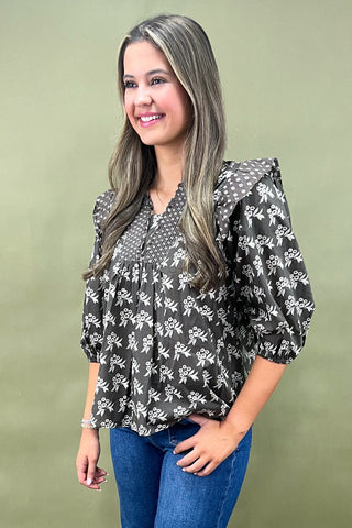 Brown floral smocked blouse with ruffle shoulders and balloon sleeves paired with wide-leg denim jeans for a chic fall outfit