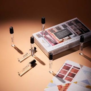 Set of Voluspa perfume samples and packaging on a warm-toned background
