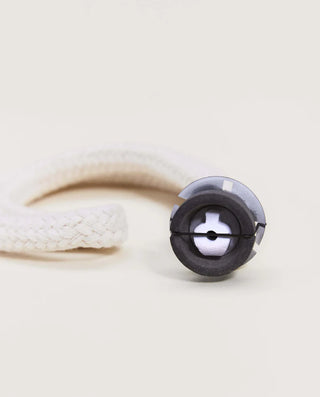 Close-up of a black and gray cylindrical object on a beige background