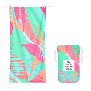 Tropical leaf patterned towel and pouch with brand label on a white background