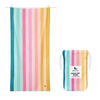 Striped beach towel with a matching pouch on a white background