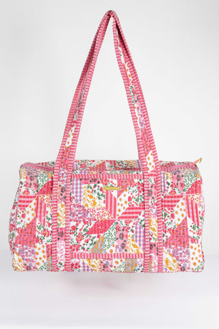 Floral patterned duffel bag on a white background