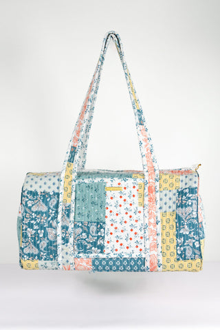 Multicolored patchwork bag with floral patterns on a white background