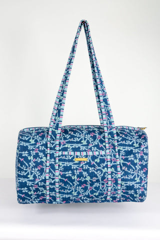 Blue patterned duffel bag on a white background