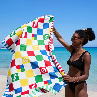Woman holding a colorful checkered towel on a beach