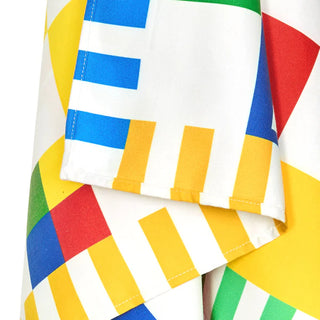 Colorful striped fabric with blue, yellow, red, and green patterns on a white background