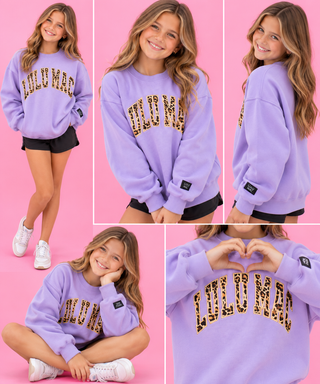 bold vertical leopard print applique lettering outlined in coordinating embroidery on a soft lavender