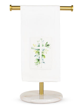 Towel holder with a white towel featuring a green leaf design on a white background