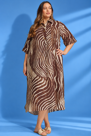 Midi Dress featuring a zebra-inspired print, collared neckline, half-button front, and flattering midi silhouette.
