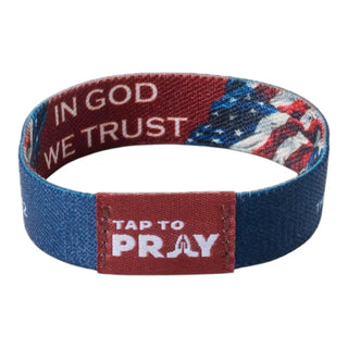 Wristband with 'In God We Trust' and 'Tap to Pray' text on a white background
