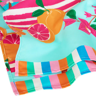 Colorful fabric with striped pattern and fruit design on a light blue background