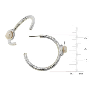 Silver hoop earrings with pearl accents on a white background with measurement scale.
