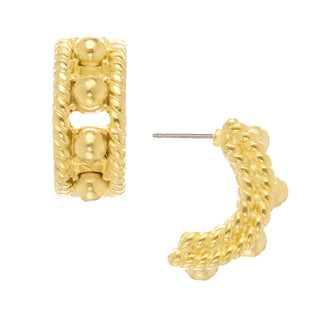 Gold hoop earrings with textured design on a white background