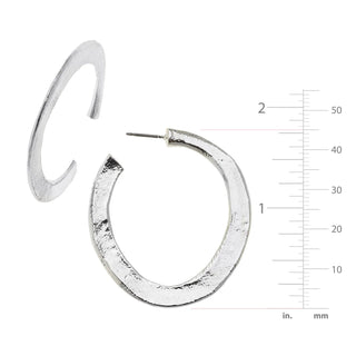 Silver hoop earrings with a measurement scale on a white background
