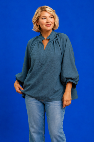 Blue Button Up Tiered Denim Top in soft 100% Tencel with a button front, chest pocket, tiered peplum hem, and relaxed fit.