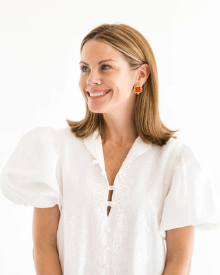 Woman wearing a white blouse with puff sleeves on a white background