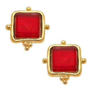 Gold-framed red square earrings on a white background