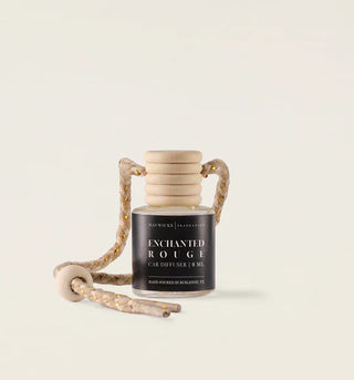 Candle diffuser with wooden handle on a light beige background