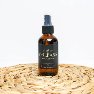 Bottle of Orleans home fragrances on a woven surface