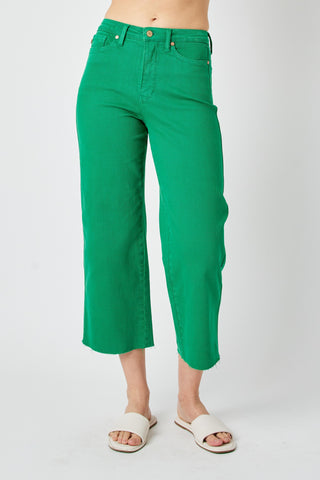 Green pants worn by a person on a white background