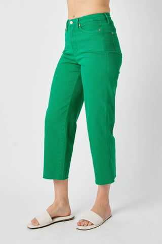 Green pants worn by a person on a white background
