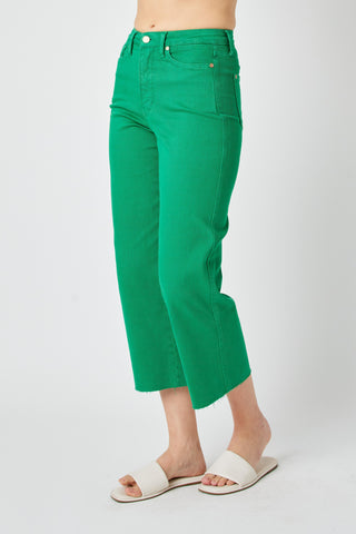Green pants worn by a person on a white background