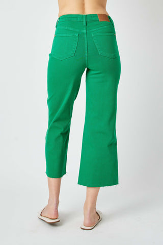Green pants worn by a person on a white background