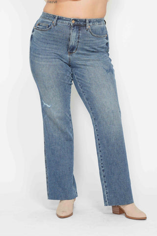 Blue jeans worn by a person on a white background