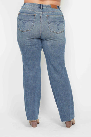 Blue jeans worn by a person on a white background