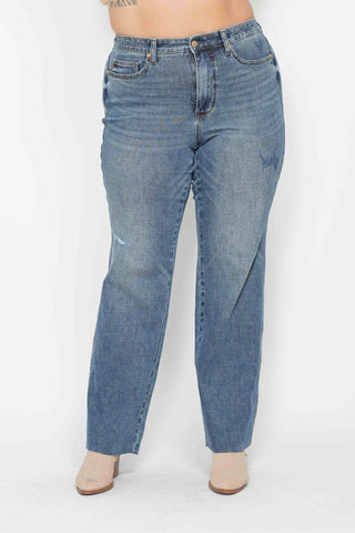Blue jeans worn by a person on a white background