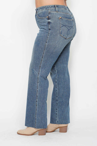 Blue jeans worn by a person on a white background