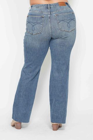 Blue jeans worn by a person on a white background