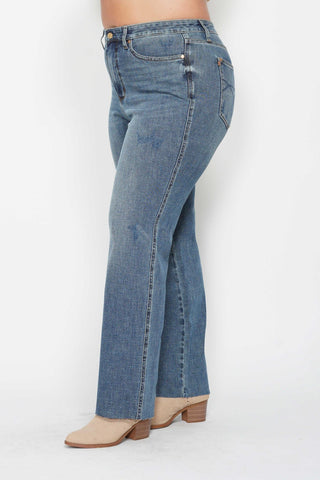 Blue jeans worn by a person on a white background