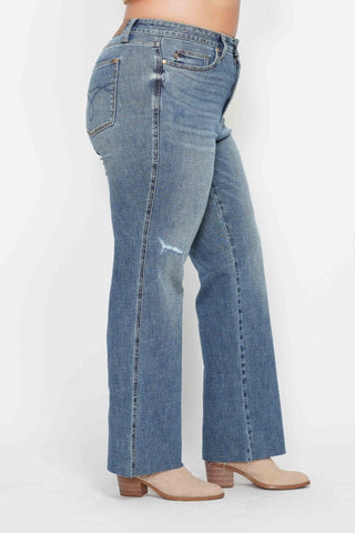 Blue jeans worn by a person on a white background