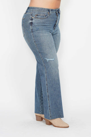 Blue jeans worn by a person on a white background