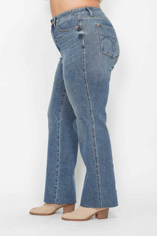 Blue jeans worn by a person on a white background