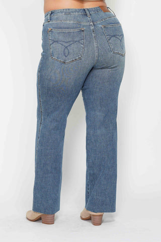 Blue jeans worn by a person on a white background