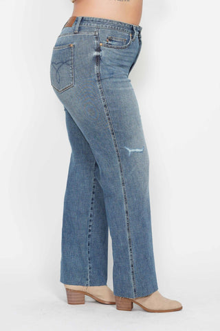 Blue jeans worn by a person on a white background