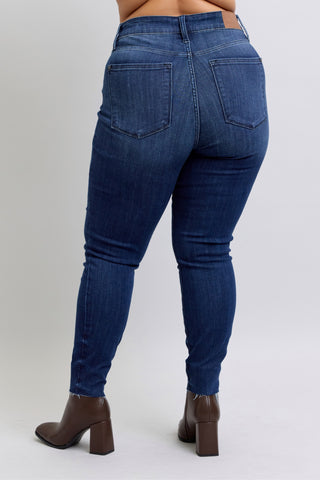 Blue jeans worn by a person on a white background