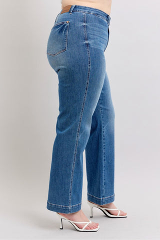 Blue jeans worn by a person on a light gray background